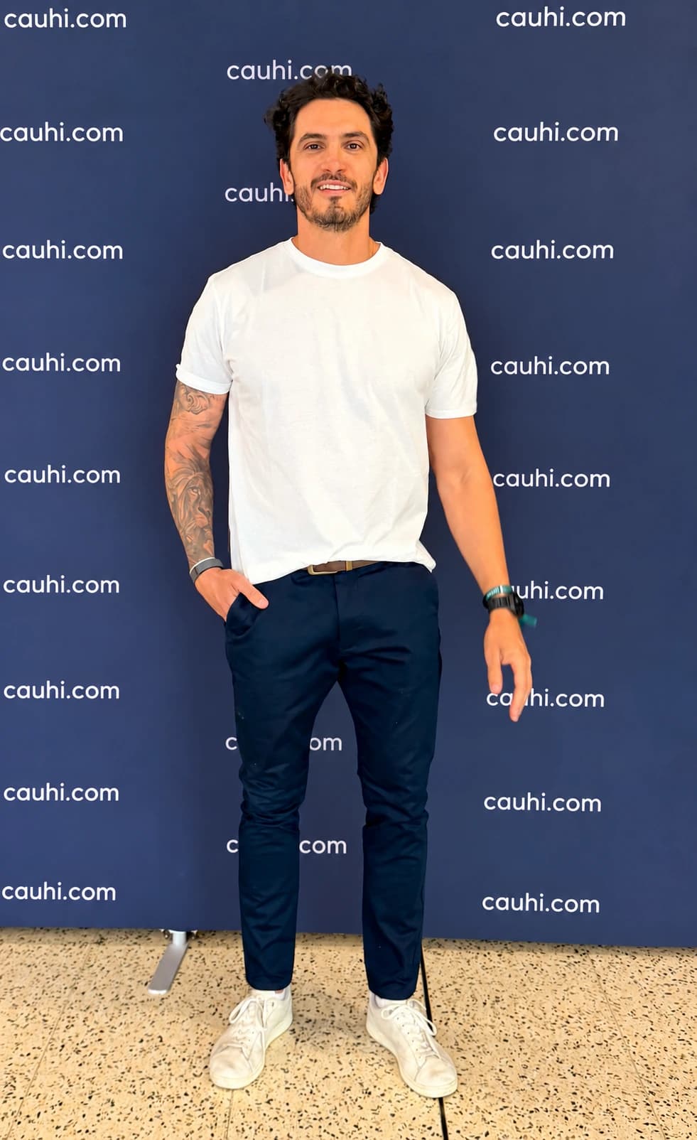 Paulo Cauhi in front of a cauhi.com backdrop.